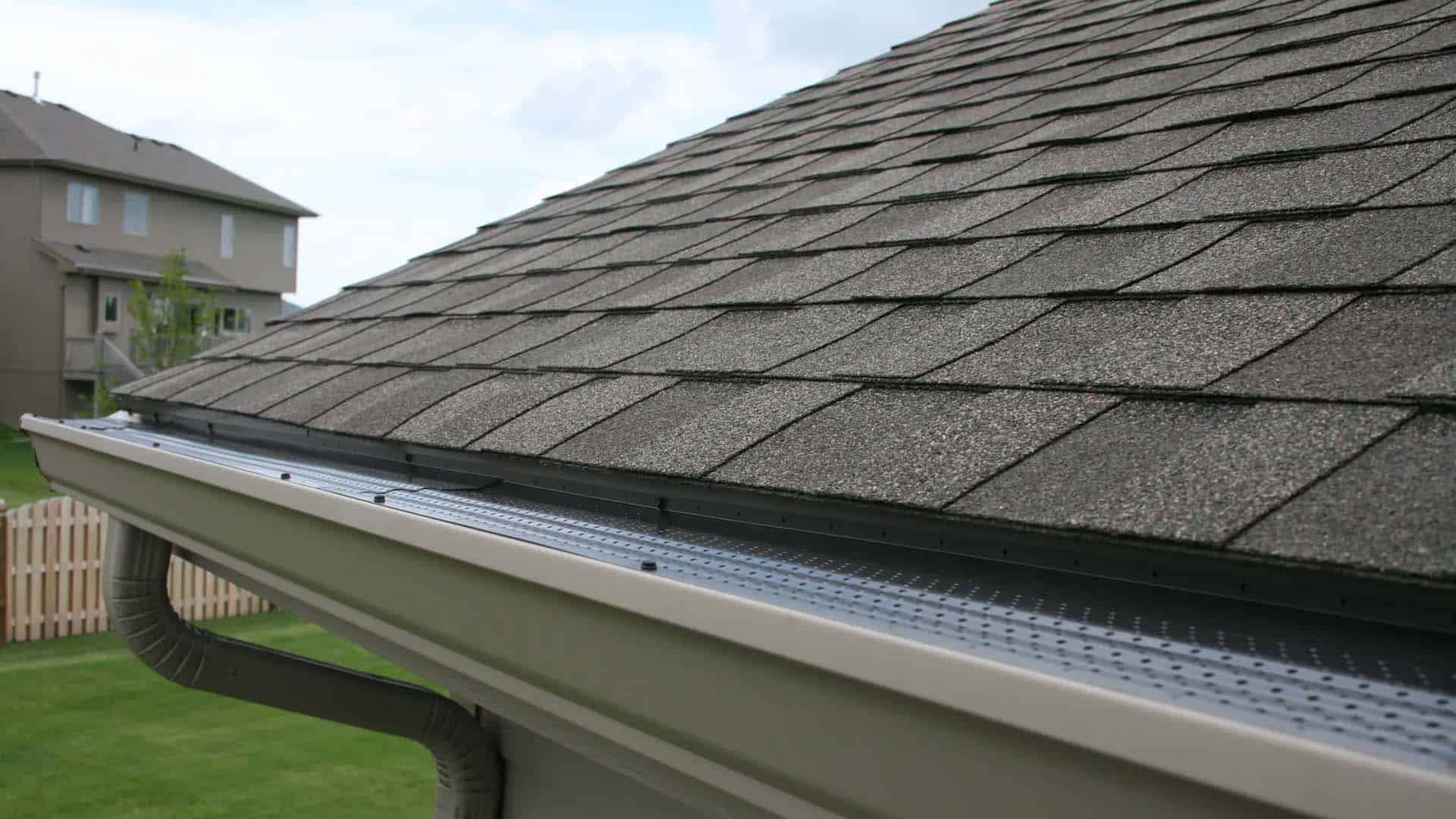 Corner or Denver house's roof showing newly installed gutter guards by Denver roofing company
