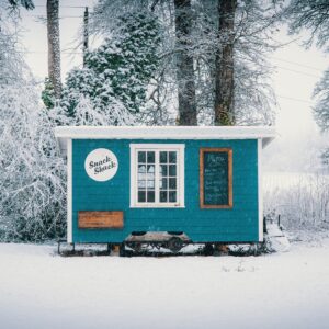 Blue backyard shed covered in snow in Colorado Springs, CO