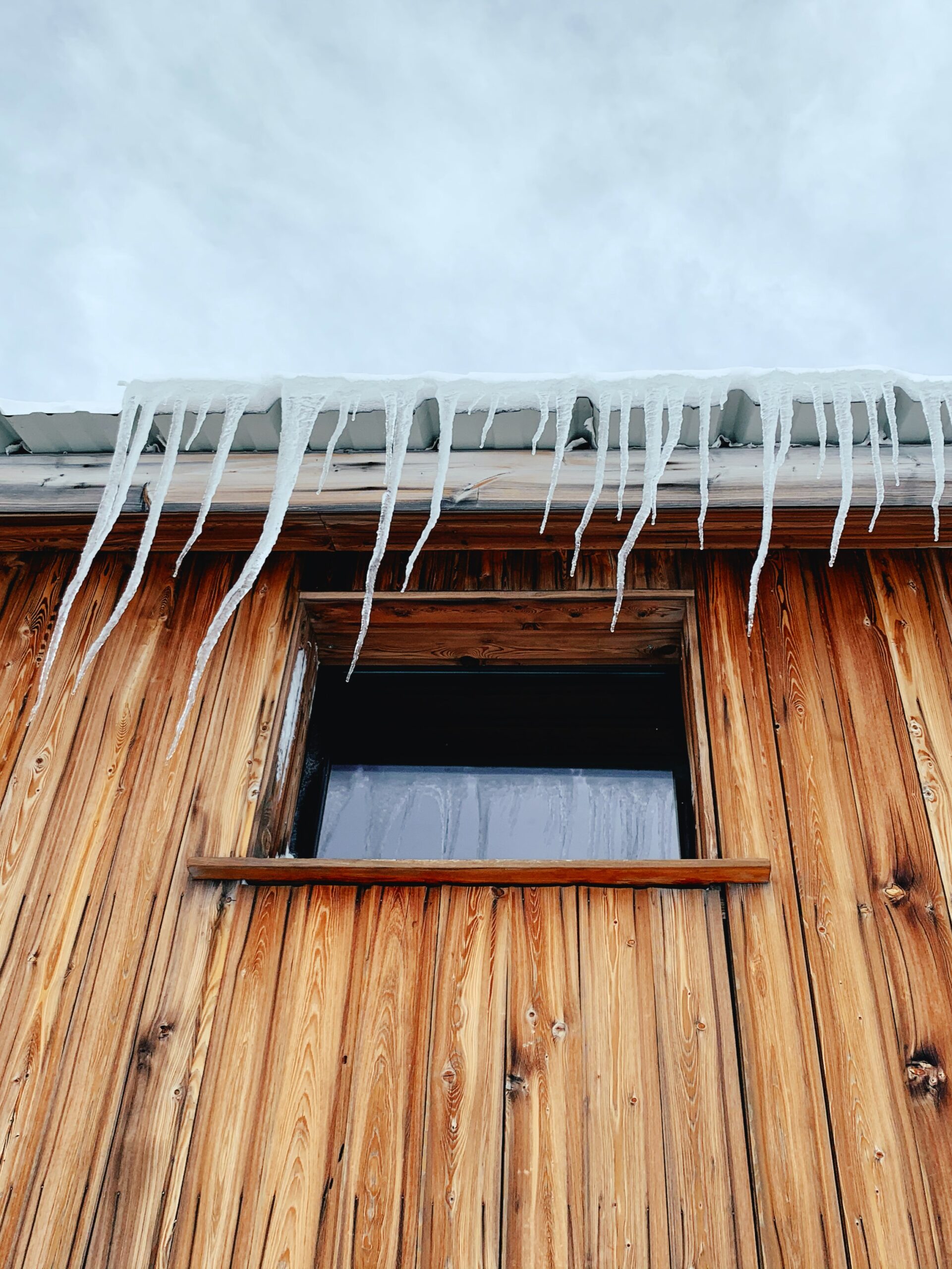 Ice Dams on Denver home in Winter causing Gutter and Roof Damage